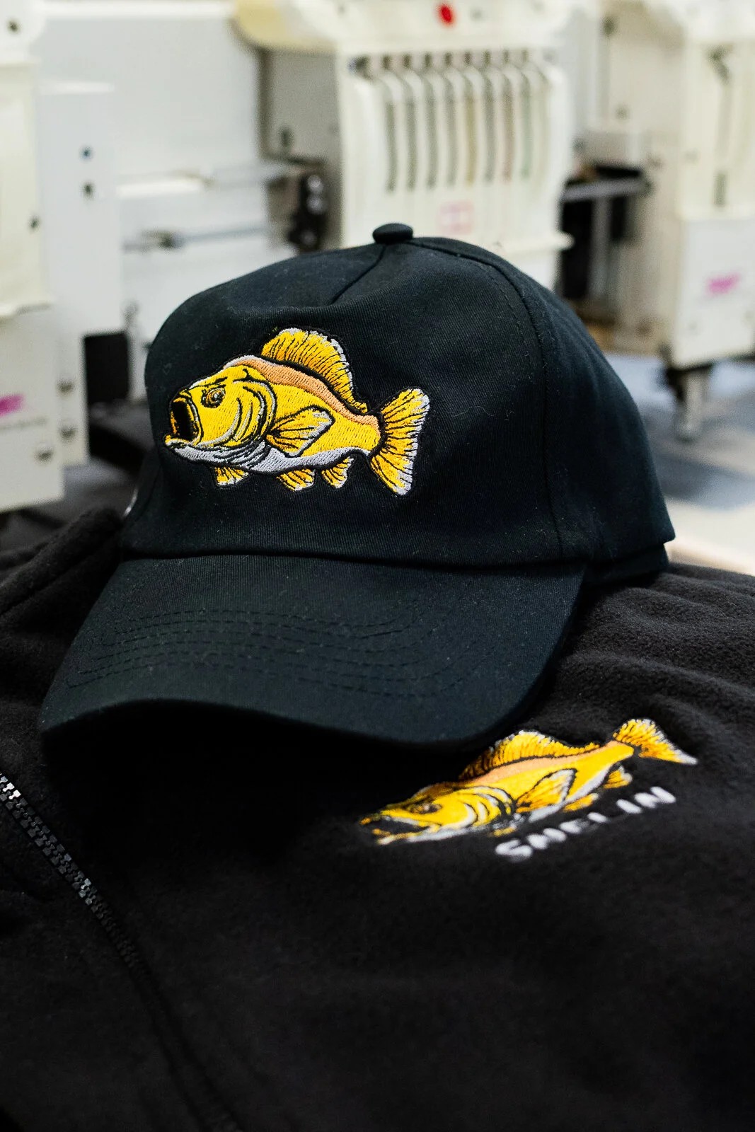 Embroidery on Regnis-branded caps and apparel